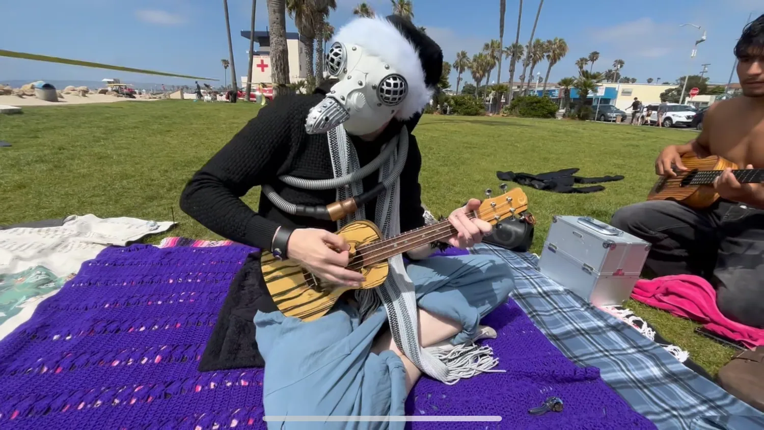 Ryan Today performing as Skex Pl'nesh, hands working the ukulele
